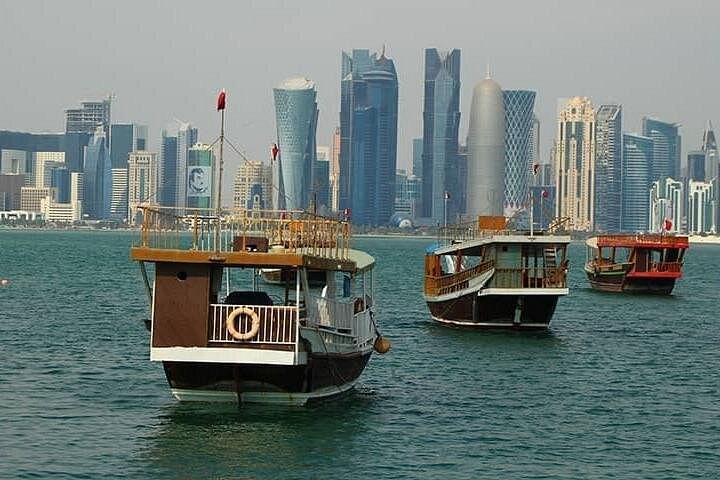 Traditional wooden dhows moored along the Doha waterfront