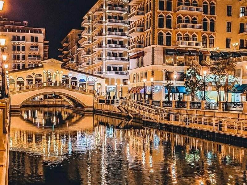 The canal and footbridge at Qanat Quartier, The Pearl-Qatar, lit at night