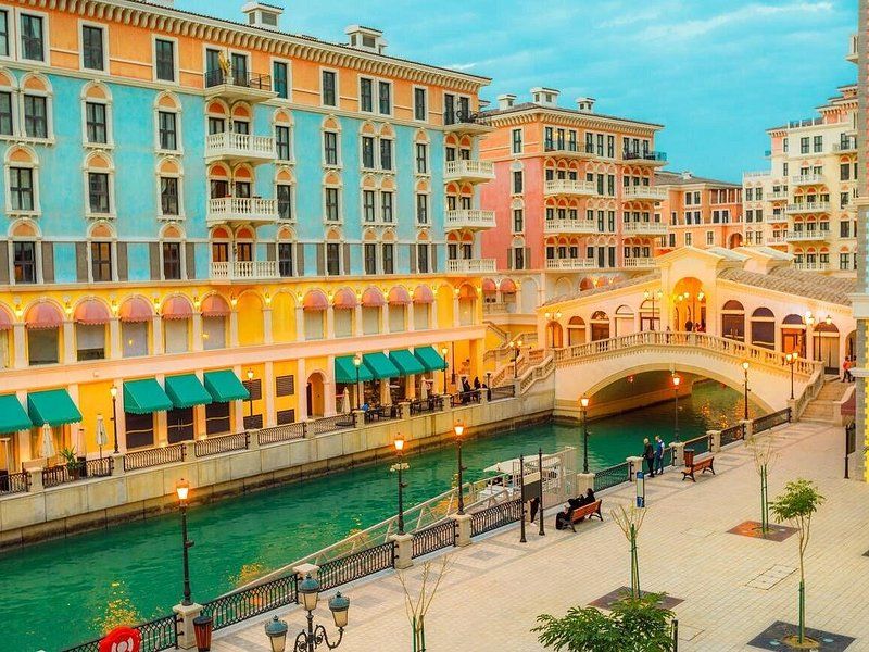 The pastel buildings and waterfront of Qanat Quartier at The Pearl-Qatar in Doha